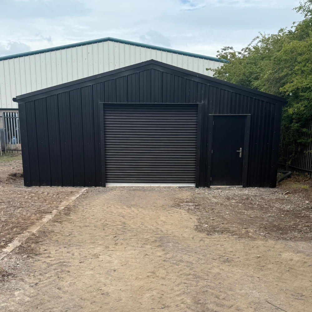 An image of the front of this steel building project in Dumfries. Featuring a roller and personnel door