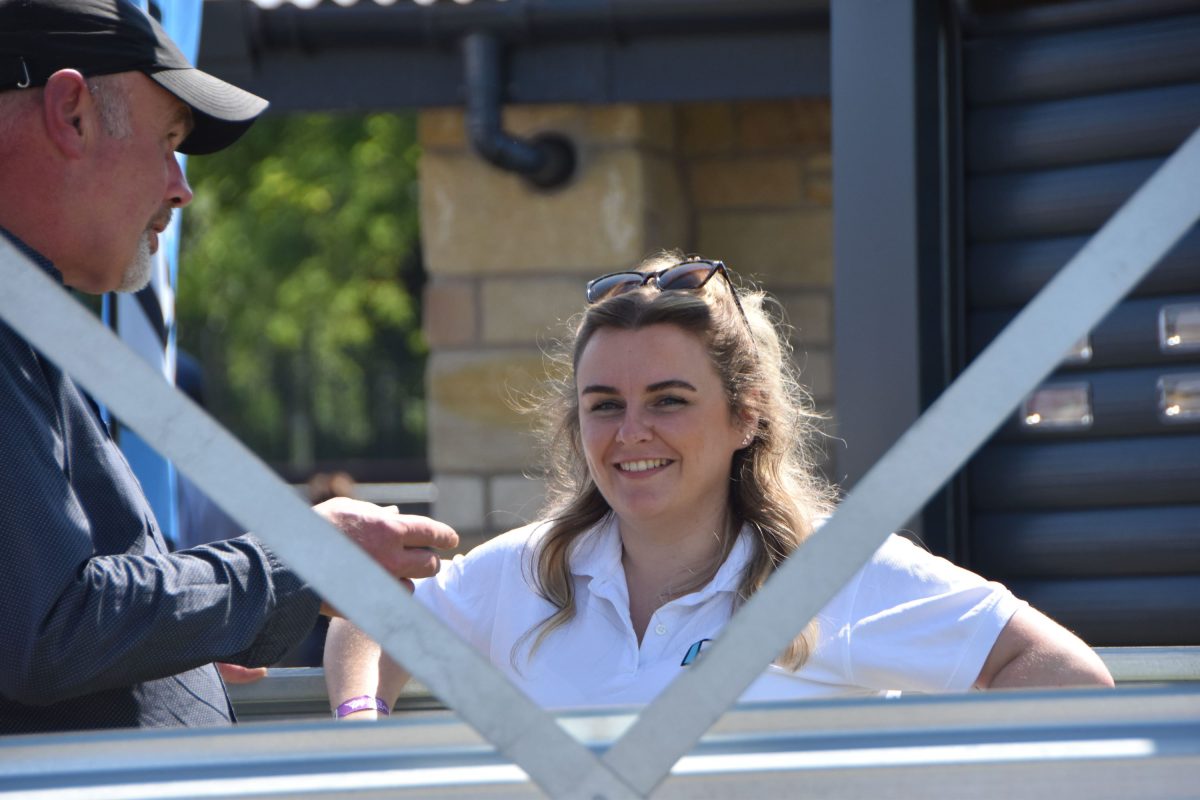 Amy smiling at the camera during a conversation with someone at the Royal Highland Show
