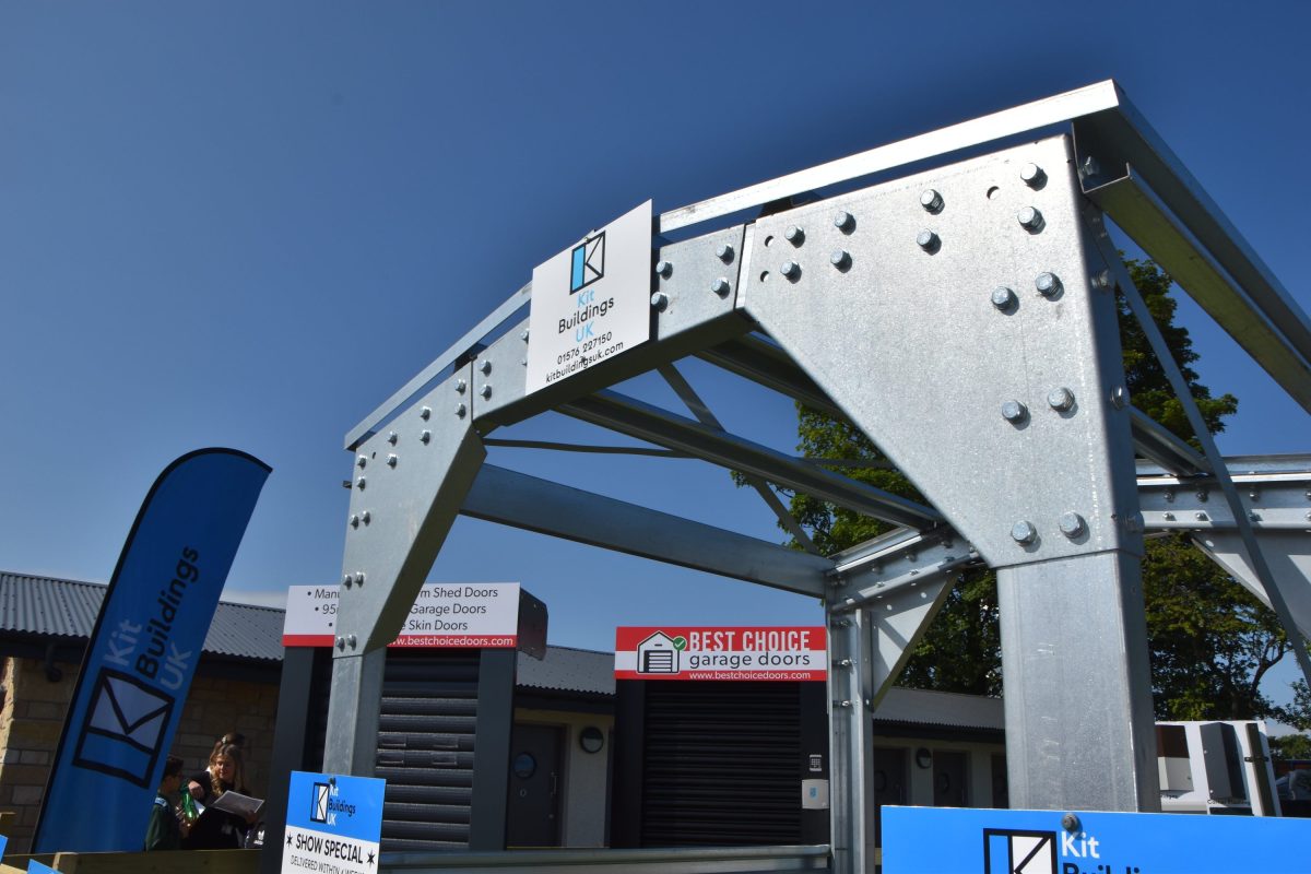 A steel frame arch with a Kit Buildings UK branded plaque at the top